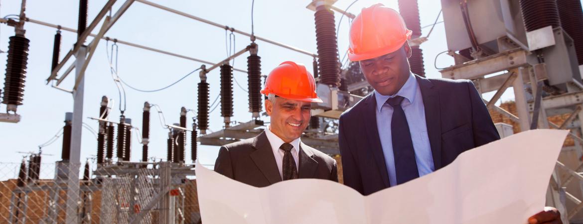 power company managers discussing blueprint